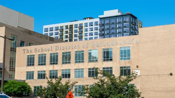 School District of Philadelphia building with large silver title lettering and taller buildings visible in background.