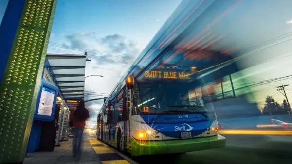 Low view looking up at bus rapid transit bus at station in Snohomish County, Washington with blur to indicate motion.